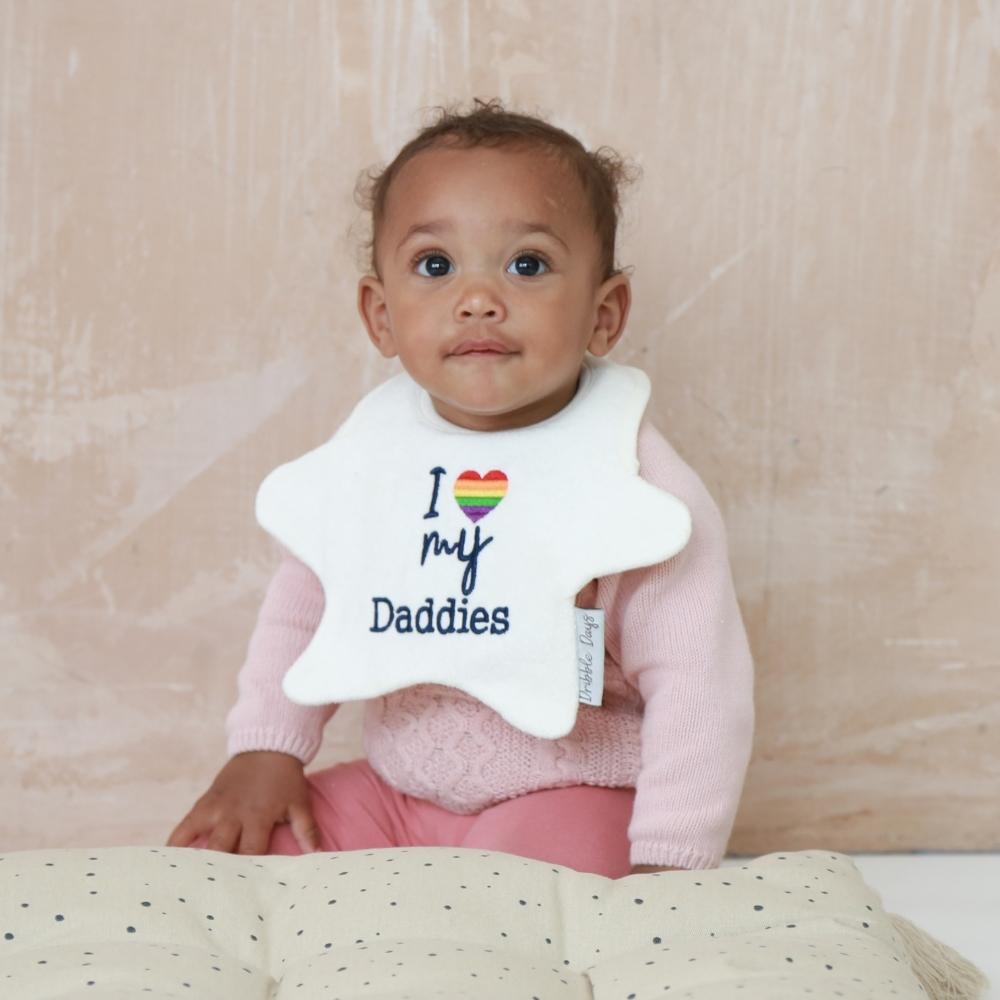 Baby wearing Pride bib with I love my daddies embroidery