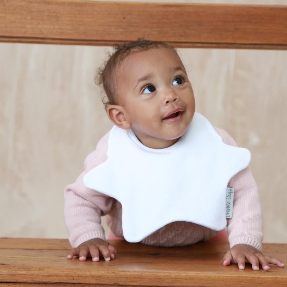 Smiling baby wears multipack star bib