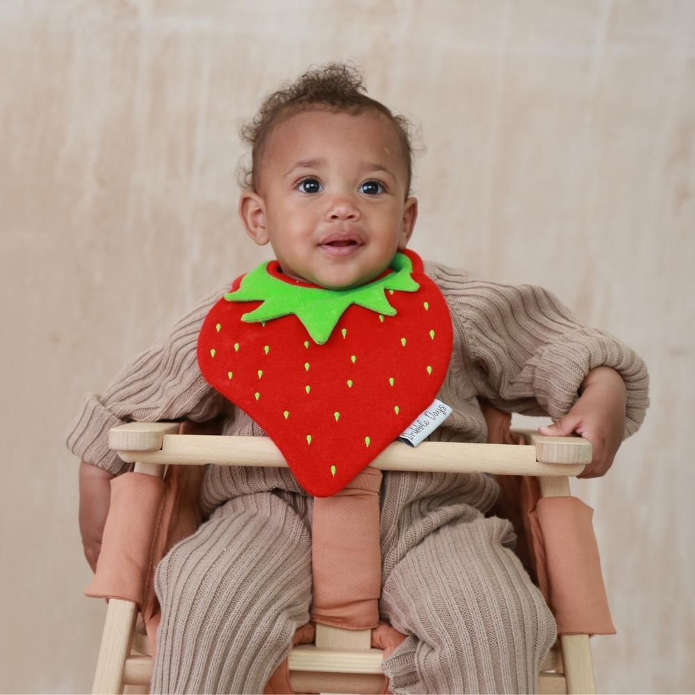 Teething baby in strawberry absorbent bib
